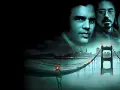 Die besetzung von Zodiac – Die Spur des Killers: Jake Gyllenhaal, Mark Ruffalo und Robert Downey Jr. blicken über eine nebelverhangene Golden Gate Bridge.