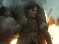 Harris Dickinson trägt einen verwundeten Kameraden durch Explosionen. Ein dramatischer Moment aus seinen Filmen.