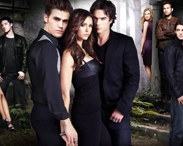 Die Hauptdarsteller der Serie "The Vampire Diaries" posieren in düsterer Atmosphäre.