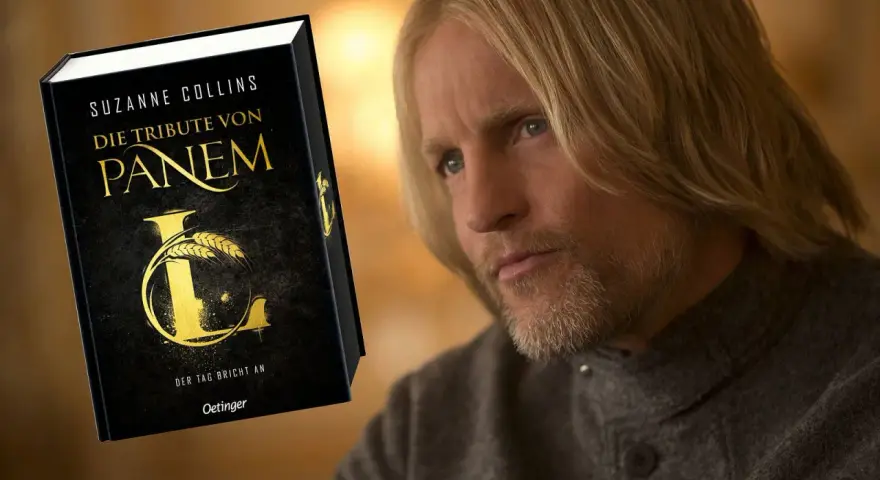 Ein Mann mit langen blonden Haaren und Bart, der an die Besetzung von "Die Tribute von Panem" erinnert, blickt nachdenklich auf das Buch "Die Tribute von Panem".