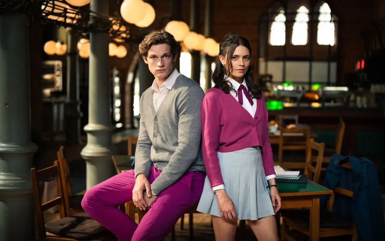 Ein Mann und eine Frau stehen in einem eleganten Raum. Sie sind die Hauptfiguren der Serie Maxton Hall Staffel 2.